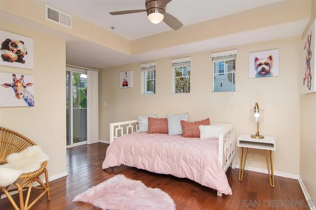 2230 Historic Decatur Road, Unit 63 San Diego, CA 92106 - Photo 16 of 25 a bedroom with a bed and wooden floor