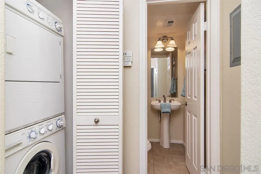 2230 Historic Decatur Road, Unit 63 San Diego, CA 92106 - Photo 19 of 25 a view of a hallway with washer and dryer