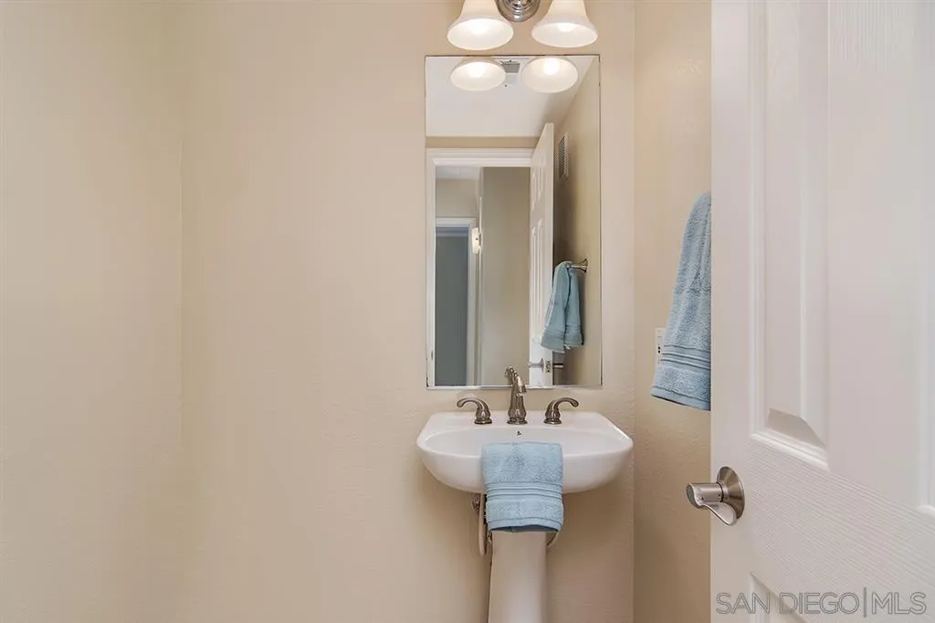 2230 Historic Decatur Road, Unit 63 San Diego, CA 92106 - Photo 20 of 25 a bathroom with a sink and a mirror