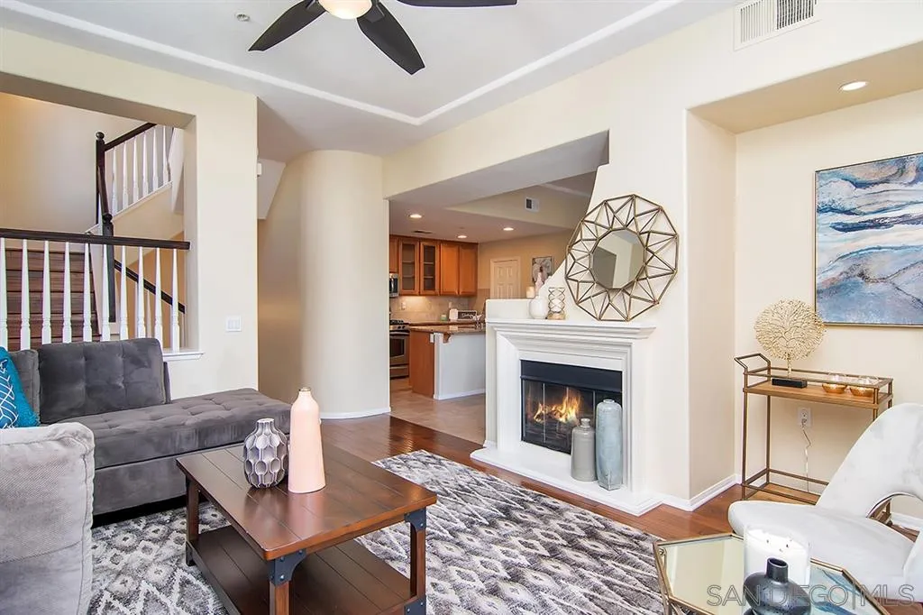 2230 Historic Decatur Road, Unit 63 San Diego, CA 92106 - Photo 3 of 25 a living room with furniture a fireplace and a table