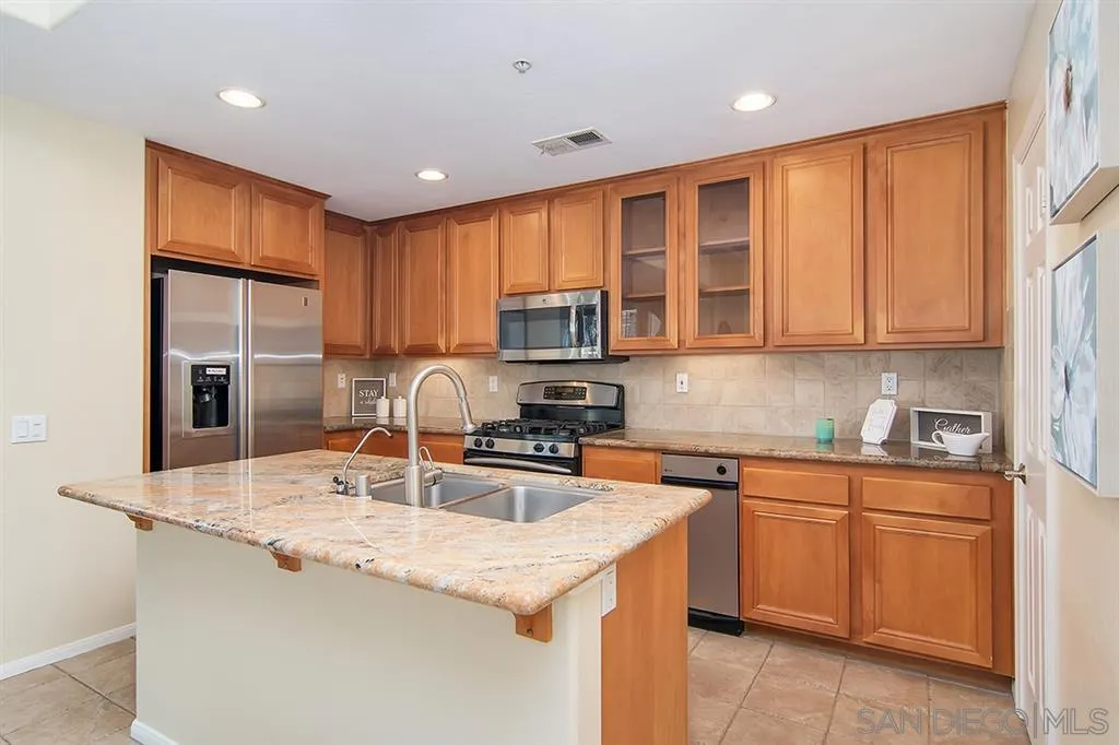 2230 Historic Decatur Road, Unit 63 San Diego, CA 92106 - Photo 4 of 25 a kitchen with granite countertop a sink stainless steel appliances and cabinets