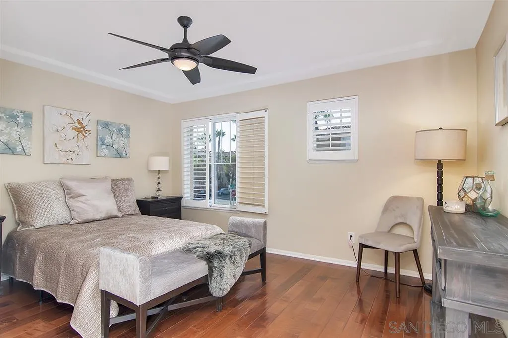 2230 Historic Decatur Road, Unit 63 San Diego, CA 92106 - Photo 9 of 25 a bedroom with a bed and a lamp on table