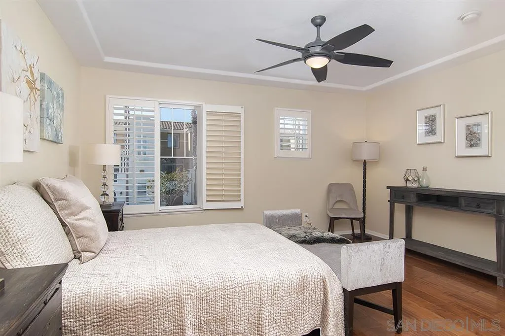 2230 Historic Decatur Road, Unit 63 San Diego, CA 92106 - Photo 10 of 25 a bedroom with a bed and a chandelier