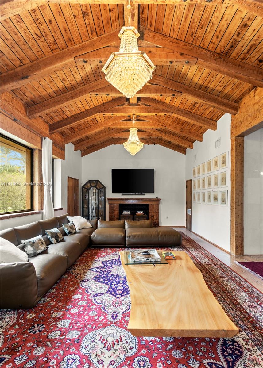 6350 Pine Tree Drive Miami Beach, FL 33140 - Photo 11 of 32 a living room with furniture and a flat screen tv