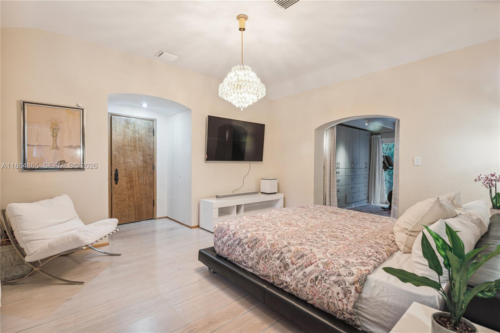 6350 Pine Tree Drive Miami Beach, FL 33140 - Photo 19 of 32 a bedroom with a bed and a flat screen tv