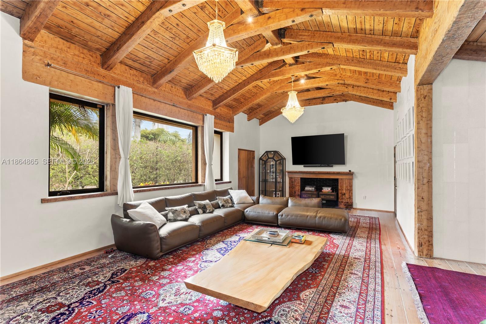 6350 Pine Tree Drive Miami Beach, FL 33140 - Photo 2 of 32 a living room with furniture and a flat screen tv