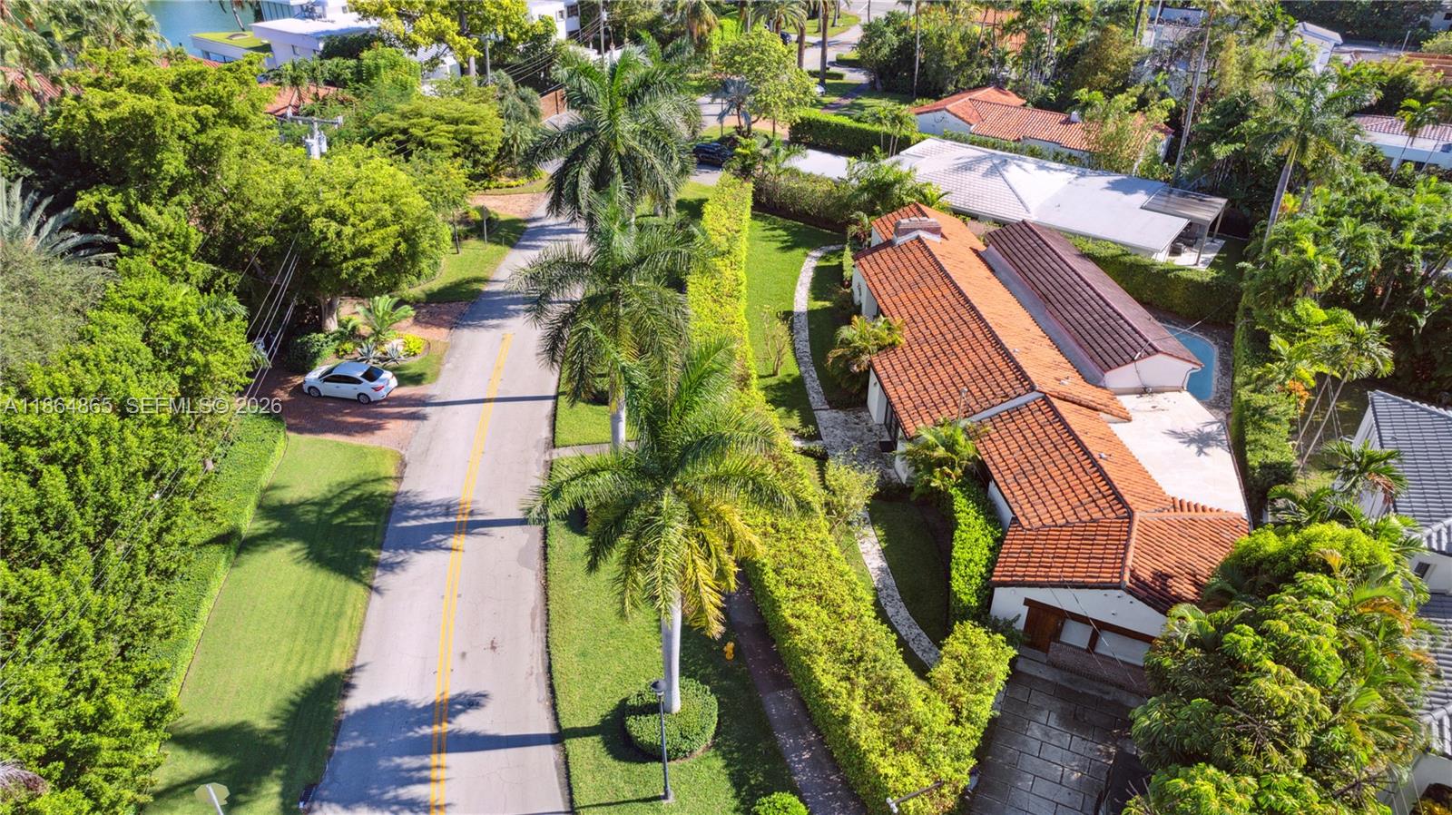 6350 Pine Tree Drive Miami Beach, FL 33140 - Photo 27 of 32 an aerial view of a house with a yard and garden