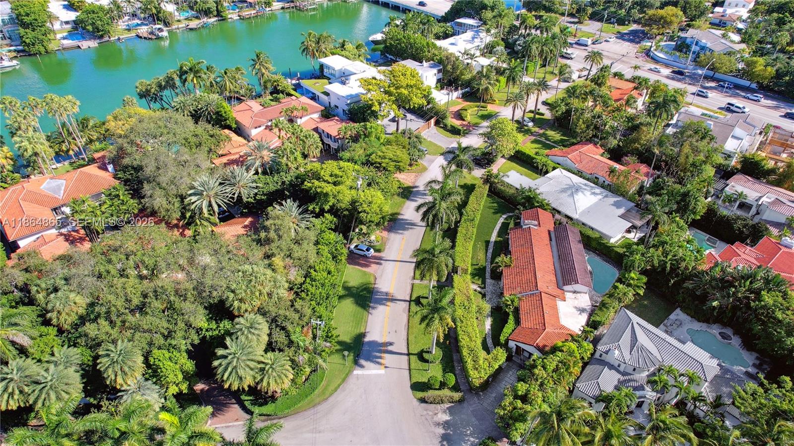 6350 Pine Tree Drive Miami Beach, FL 33140 - Photo 28 of 32 an aerial view of residential houses with outdoor space and trees all around
