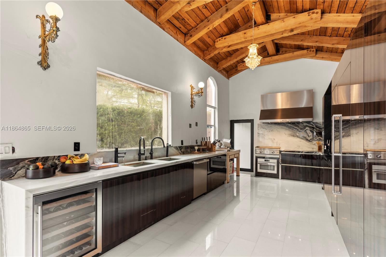 6350 Pine Tree Drive Miami Beach, FL 33140 - Photo 4 of 32 a kitchen with stainless steel appliances a sink stove and refrigerator