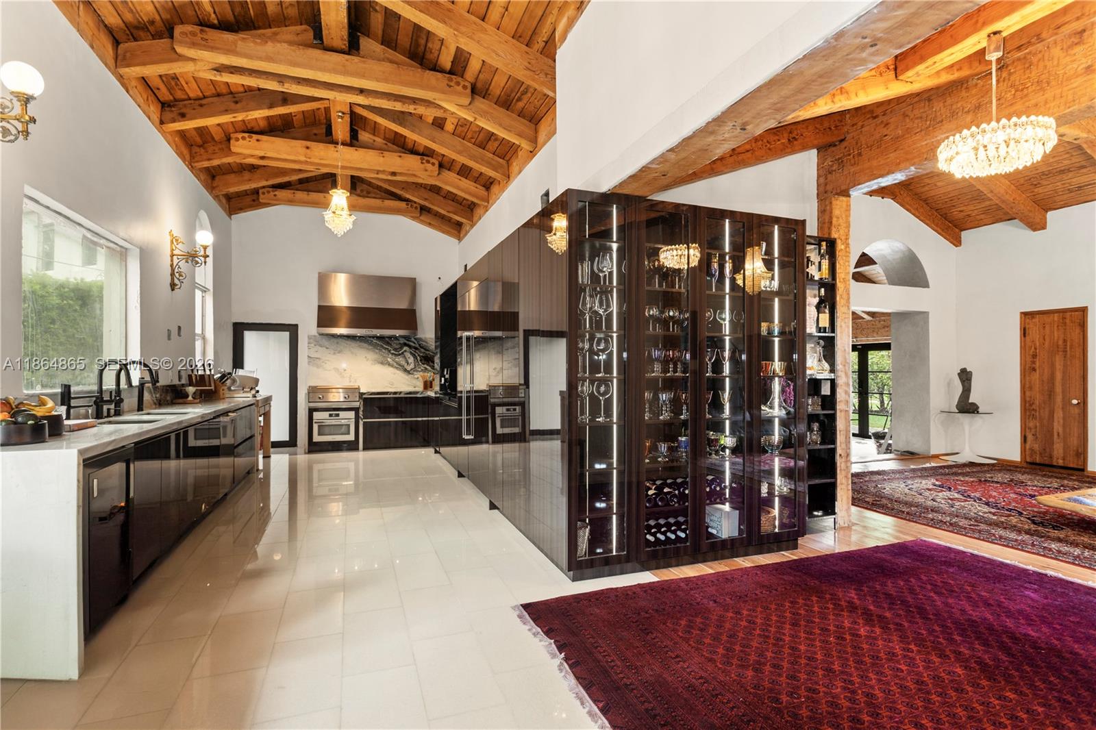 6350 Pine Tree Drive Miami Beach, FL 33140 - Photo 5 of 32 a view of a kitchen with refrigerator and windows