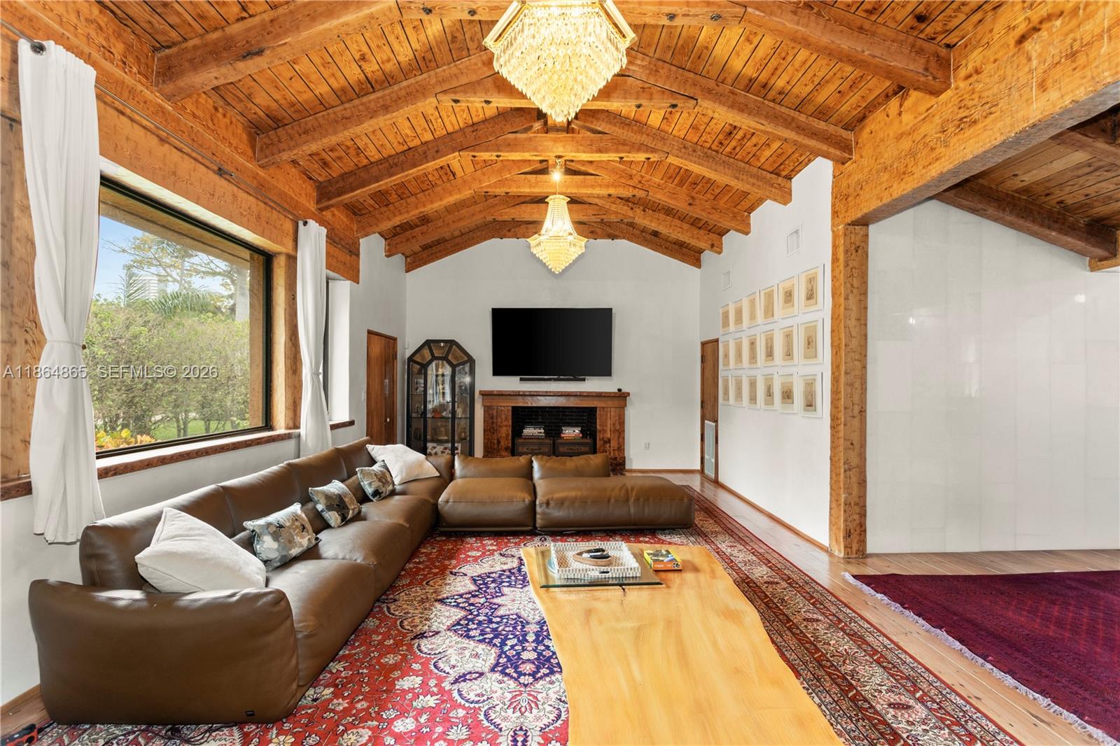 6350 Pine Tree Drive Miami Beach, FL 33140 - Photo 8 of 32 a living room with furniture and a flat screen tv