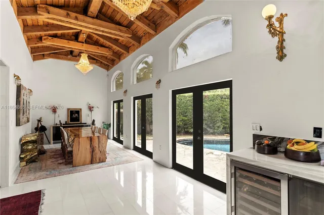 a living room with furniture a large window and a flat screen tv