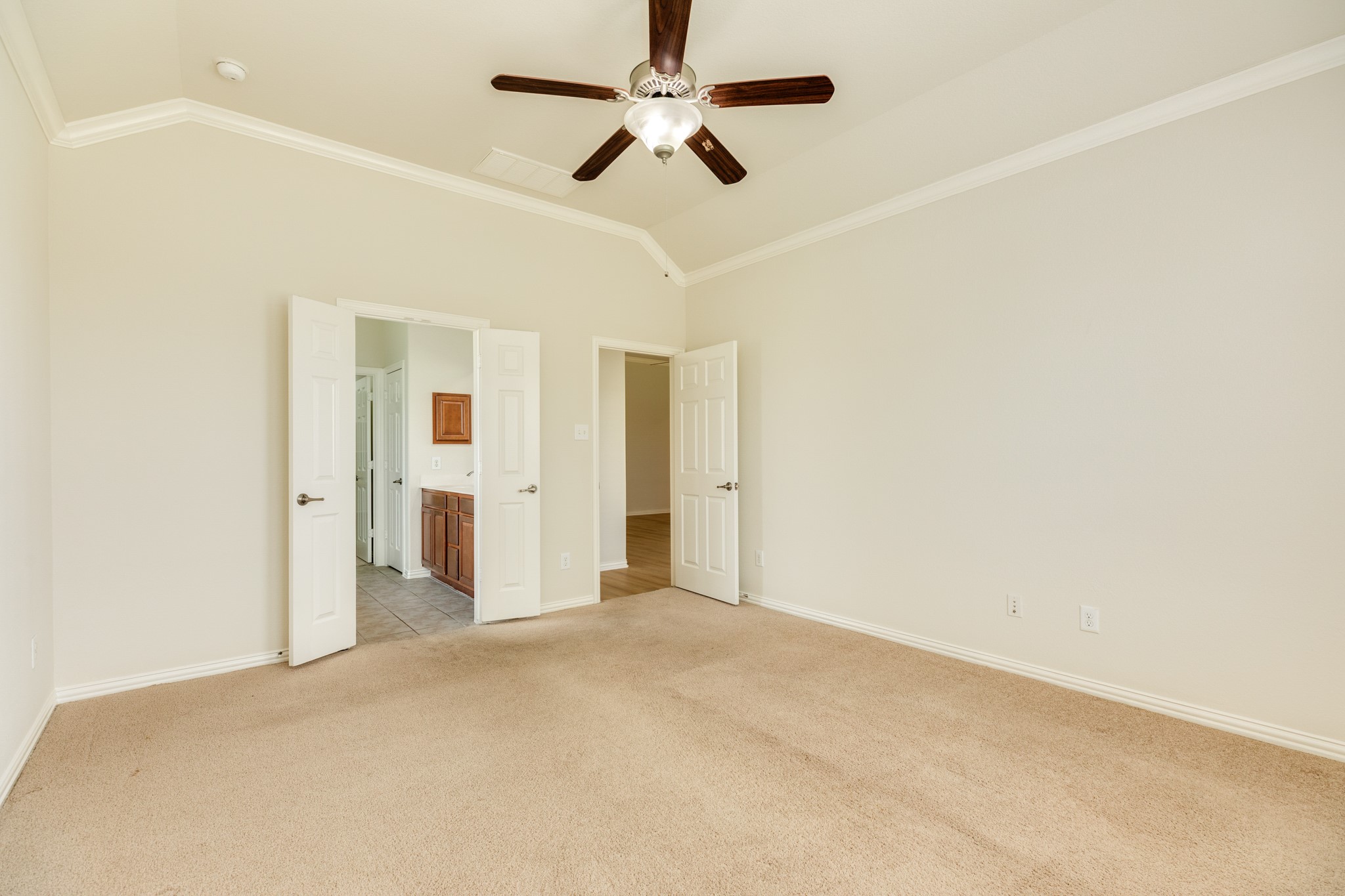 13417 Star Creek Lane Rosharon, TX 77583 - Photo 19 of 41 This view captures the entrance to the primary suite and the double doors leading to the primary bath.