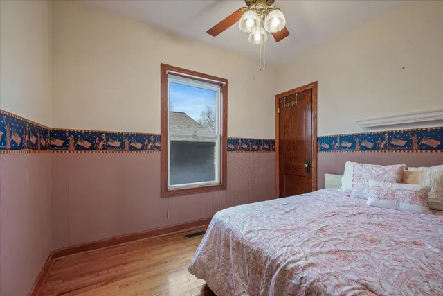 a bedroom with a bed and a chandelier