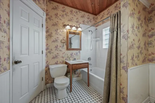 a bathroom with a toilet a sink and a shower
