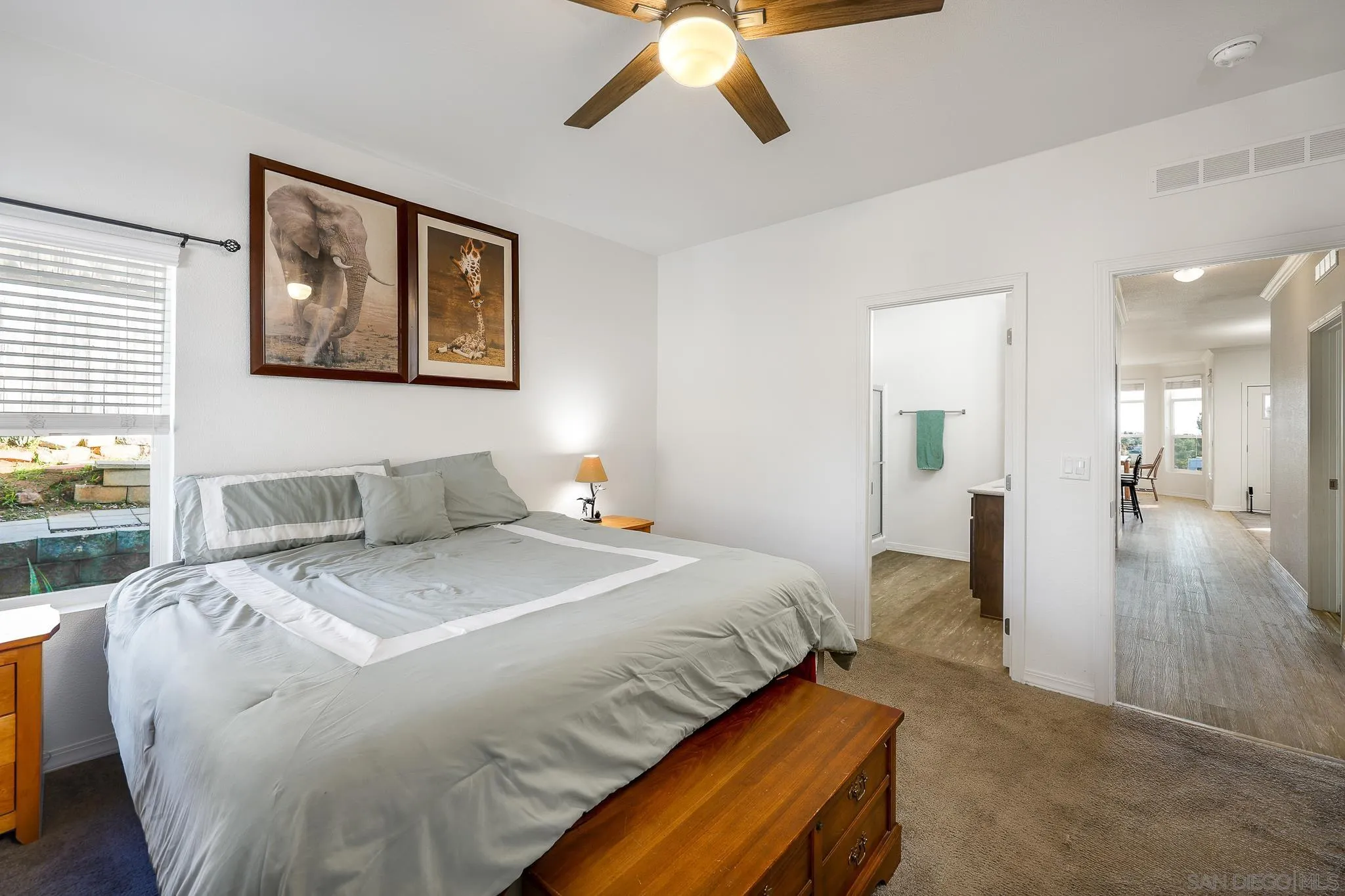 250 La Cresta Heights Road, Unit SPC 12 El Cajon, CA 92021 - Photo 20 of 37 a spacious bedroom with a bed and a chandelier