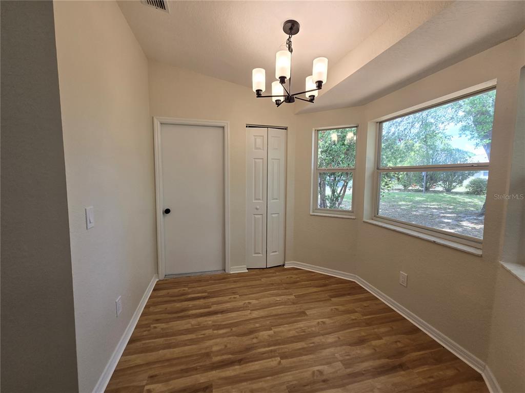6121 Southwest 103rd Loop Ocala, FL 34476 - Photo 16 of 32 a view of a livingroom with a chandelier fan and windows