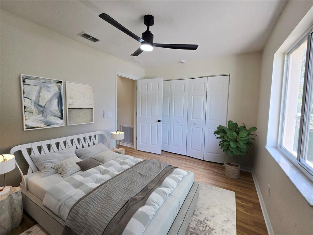 6121 Southwest 103rd Loop Ocala, FL 34476 - Photo 20 of 32 a bedroom with a bed and a couch