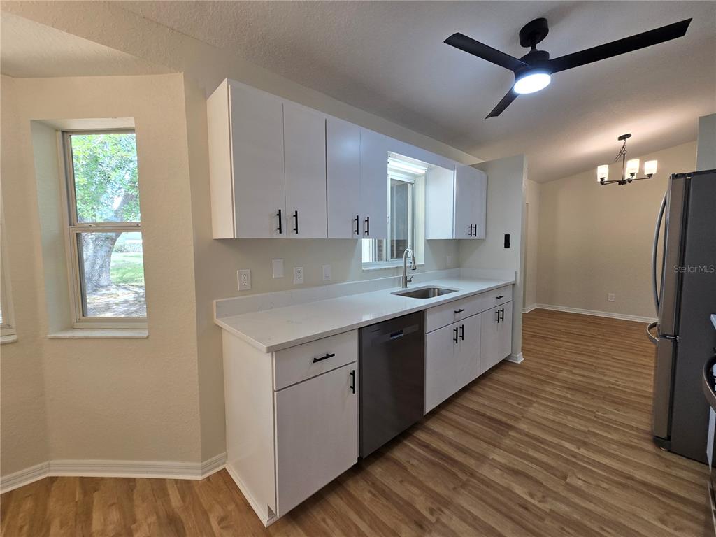 6121 Southwest 103rd Loop Ocala, FL 34476 - Photo 22 of 32 a kitchen with a sink appliances cabinets and a window