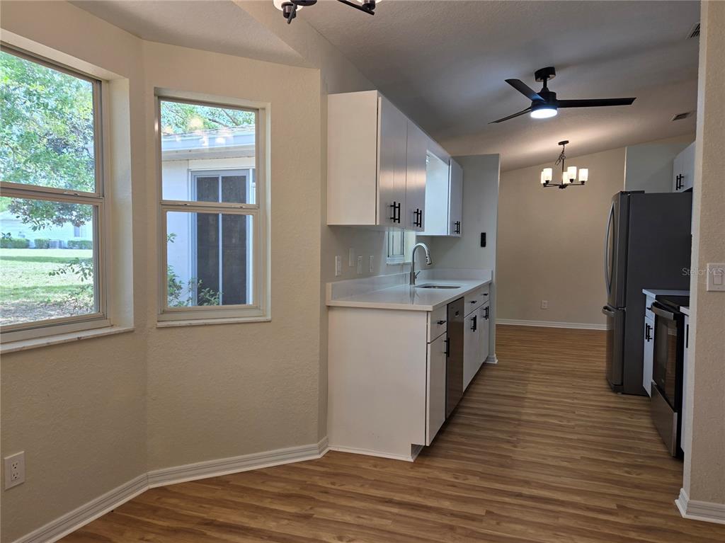 6121 Southwest 103rd Loop Ocala, FL 34476 - Photo 26 of 32 a kitchen with a sink refrigerator and microwave