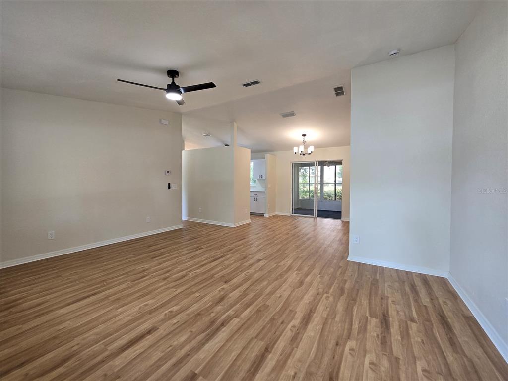 6121 Southwest 103rd Loop Ocala, FL 34476 - Photo 5 of 32 a view of empty room with wooden floor and fan