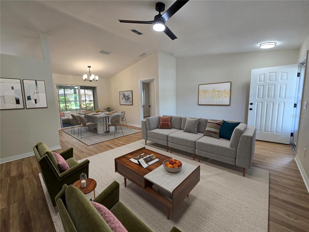 6121 Southwest 103rd Loop Ocala, FL 34476 - Photo 6 of 32 a living room with furniture and a wooden floor