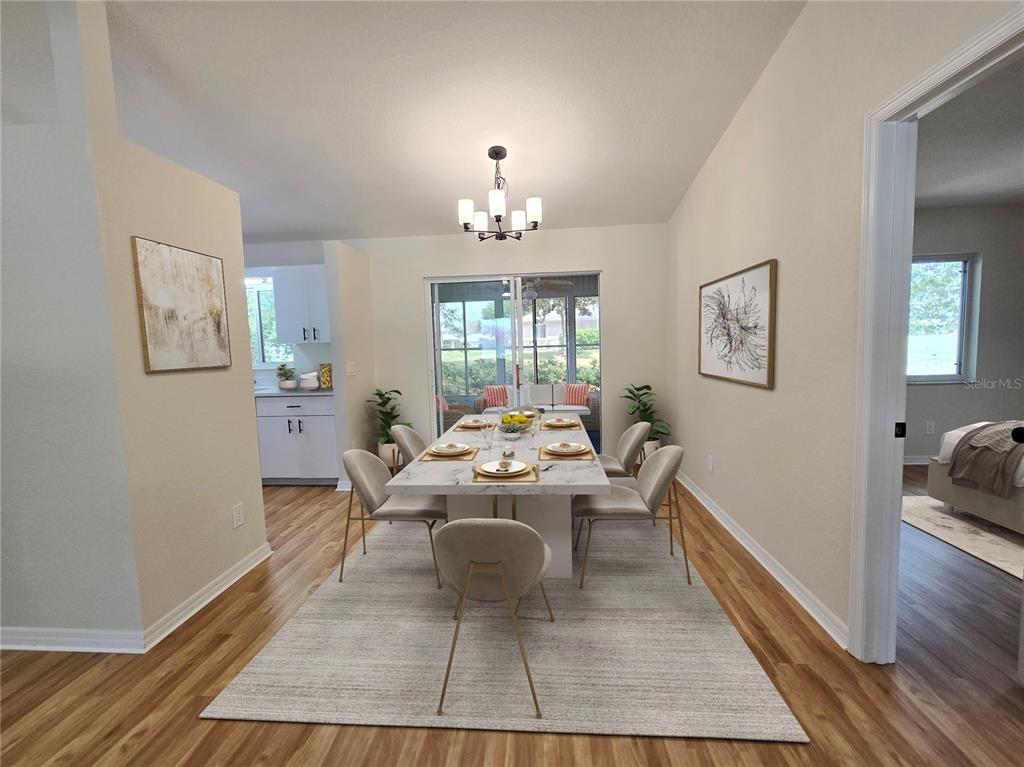 6121 Southwest 103rd Loop Ocala, FL 34476 - Photo 8 of 32 a dining room with wooden floor and white walls