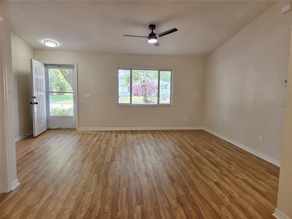 6121 Southwest 103rd Loop Ocala, FL 34476 - Photo 10 of 32 wooden floor in an empty room with a window