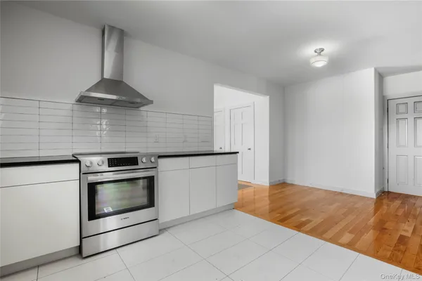 a kitchen with granite countertop a stove and a sink