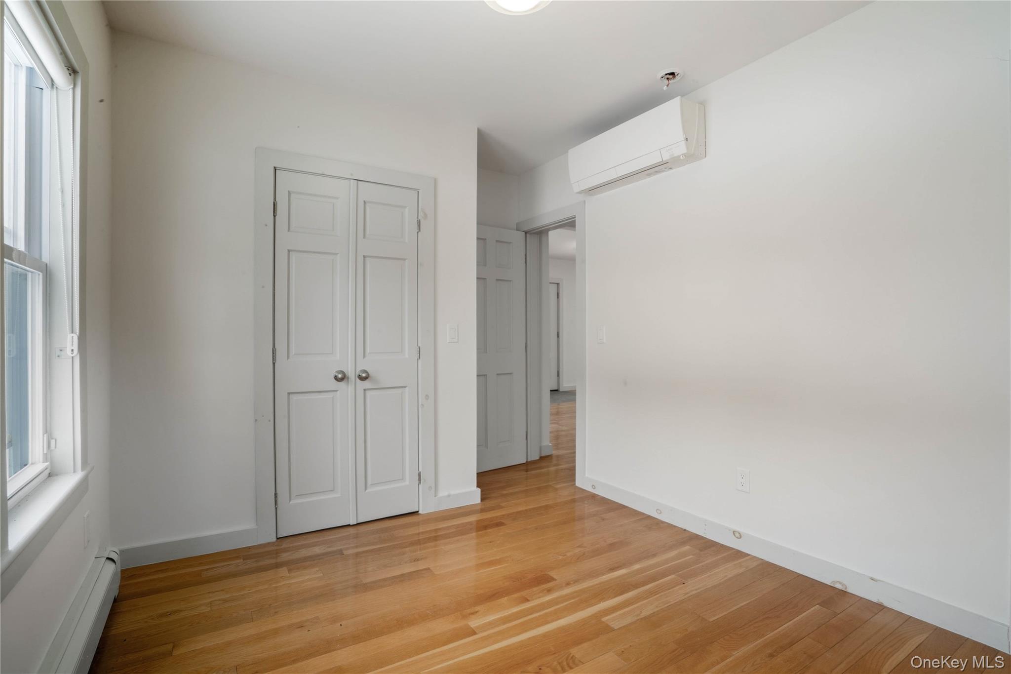 1091 Albany Post Road Gardiner, NY 12525 - Photo 14 of 50 a view of an empty room with wooden floor and a window