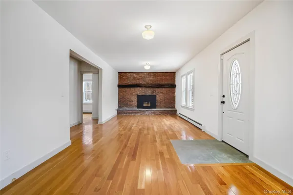 wooden floor in an empty room with a fireplace