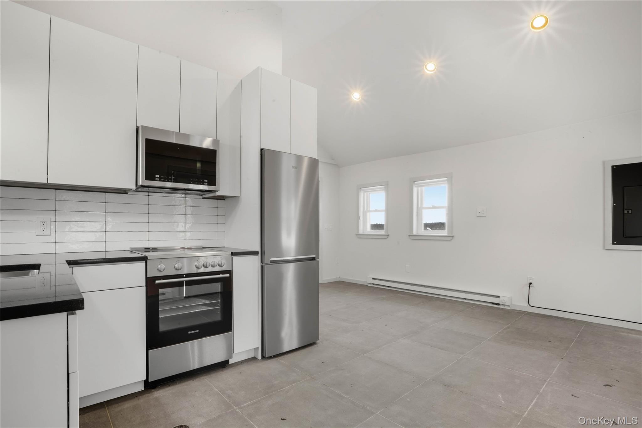 1091 Albany Post Road Gardiner, NY 12525 - Photo 37 of 50 a kitchen with stainless steel appliances a stove microwave and refrigerator