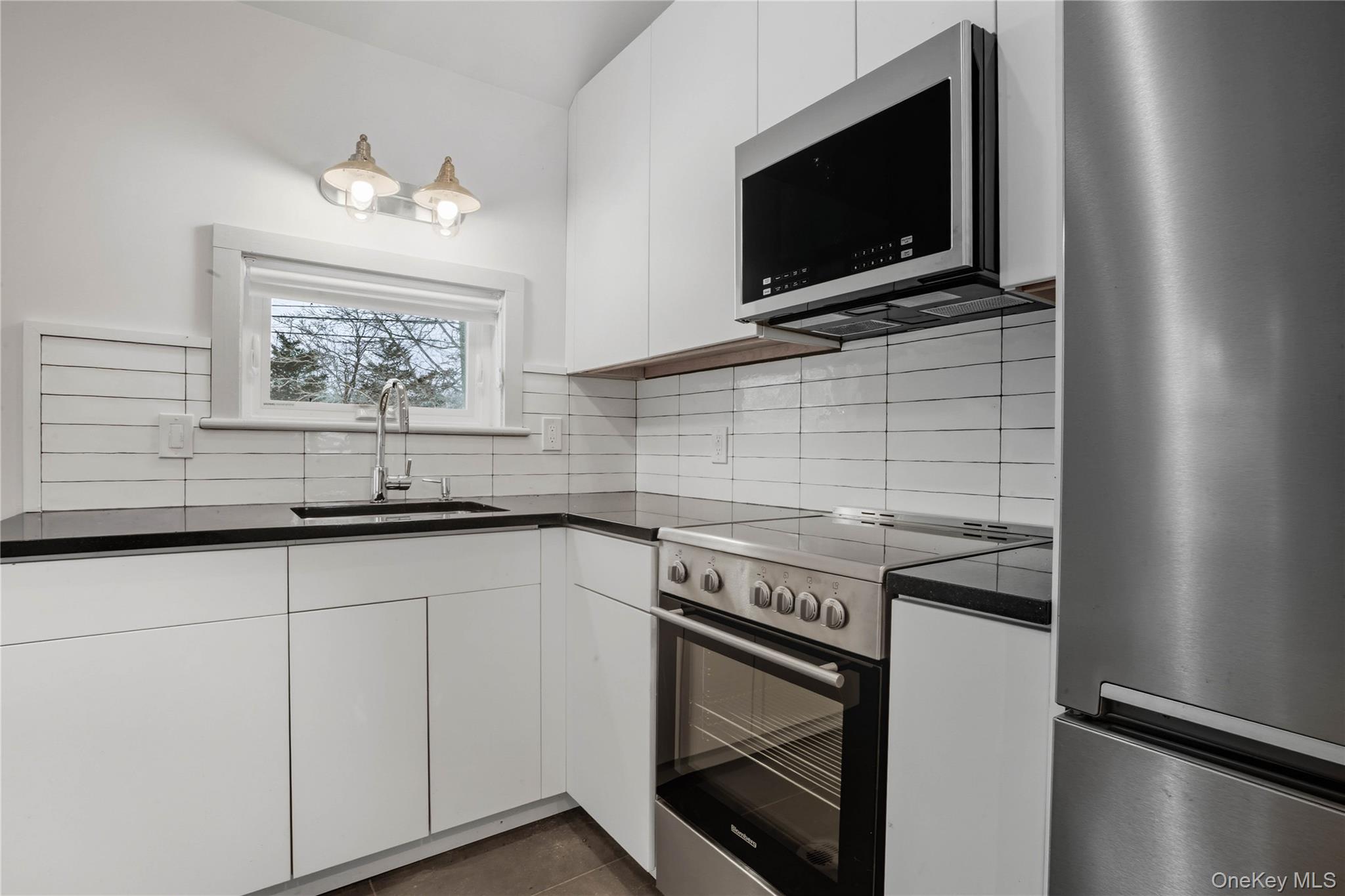 1091 Albany Post Road Gardiner, NY 12525 - Photo 39 of 50 a kitchen with stainless steel appliances white cabinets and a stove top oven