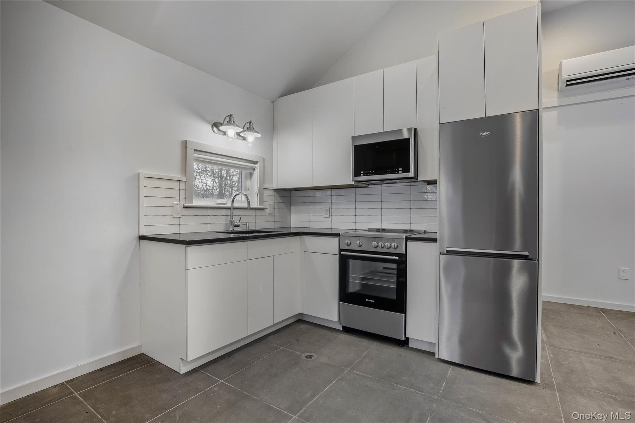 1091 Albany Post Road Gardiner, NY 12525 - Photo 40 of 50 a kitchen with stainless steel appliances granite countertop a refrigerator a stove a microwave and a sink