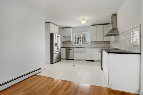 a kitchen with stainless steel appliances granite countertop a refrigerator and a stove top oven