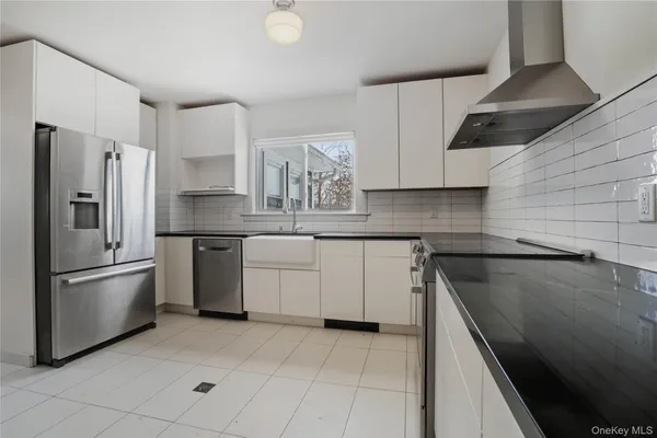a kitchen with a sink stainless steel appliances and cabinets