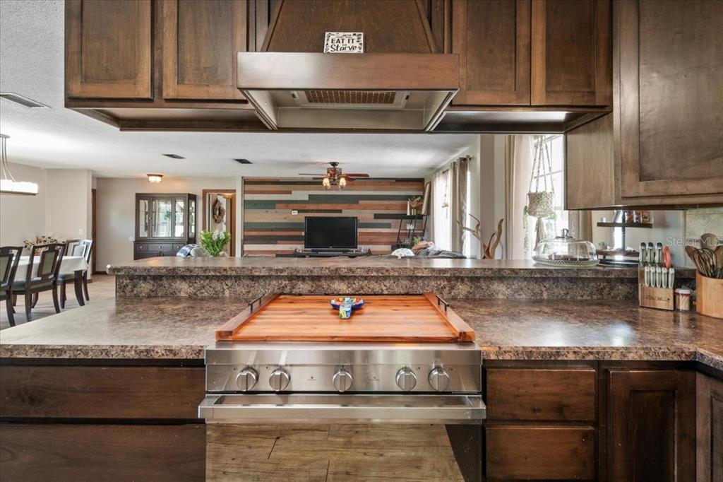 7422 County Road 231 Lake Butler, FL 32054 - Photo 17 of 57 a kitchen with stainless steel appliances granite countertop a sink a stove and a microwave