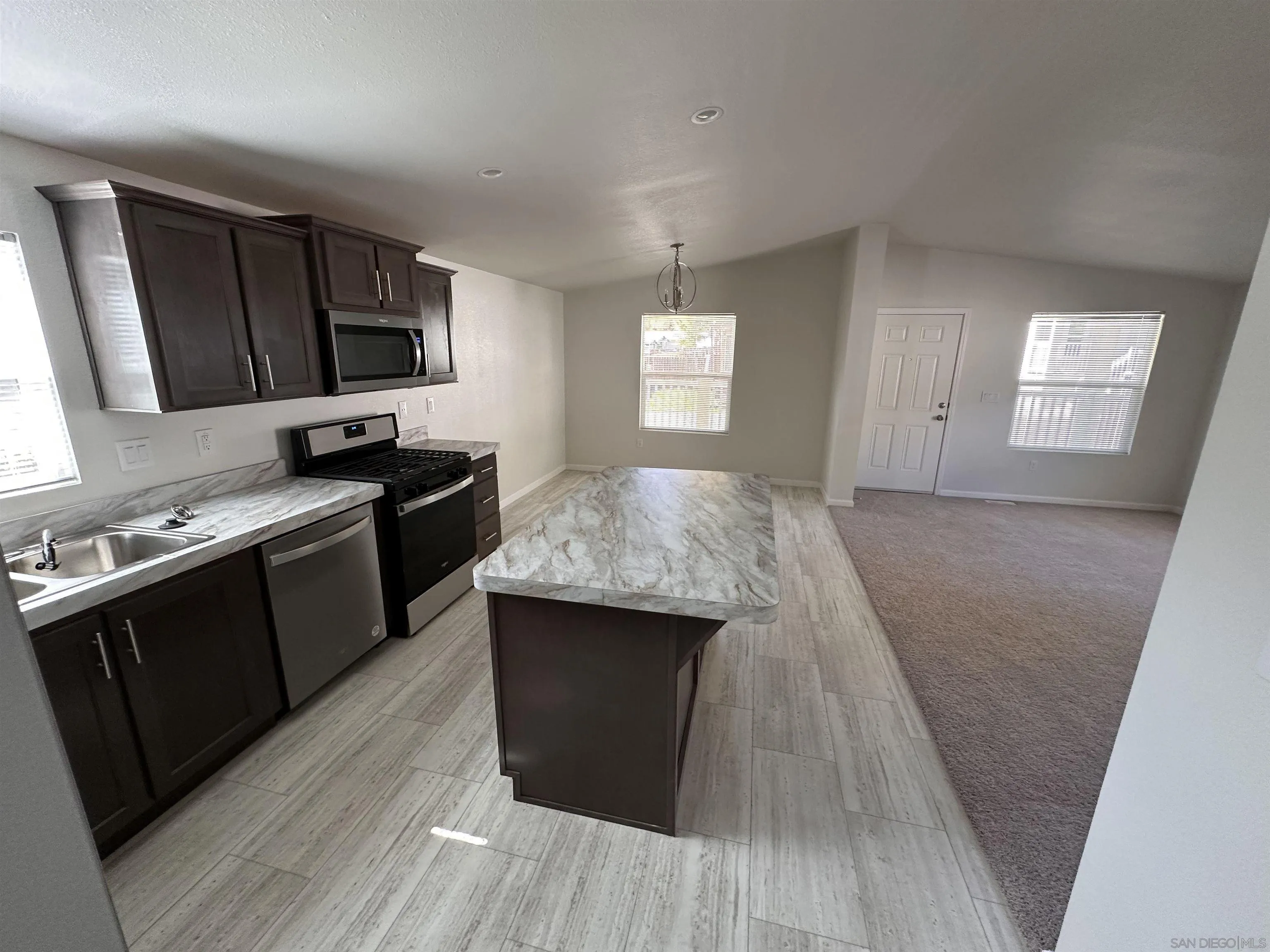 a kitchen with a sink stove and microwave