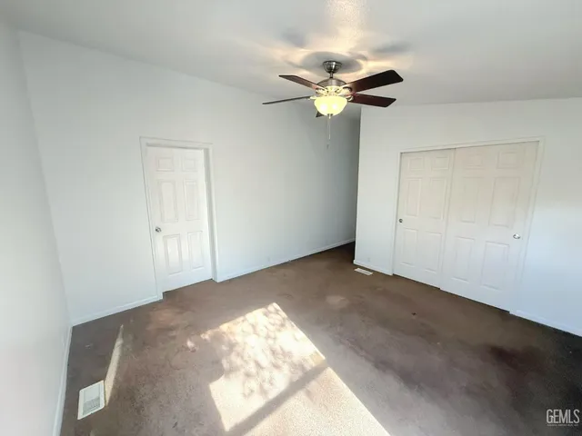 a view of a livingroom with a chandelier fan