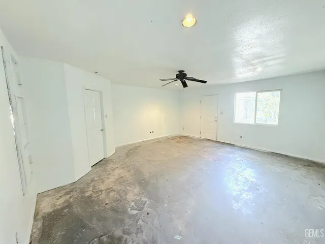 an empty room with a empty space and windows