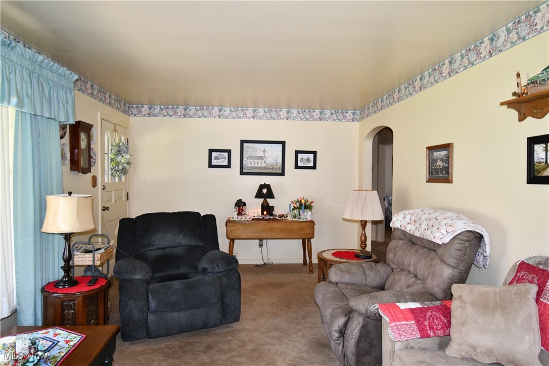 4659 Canfield Road Canfield, OH 44406 - Photo 7 of 34 Living room with carpet floors and arched walkways