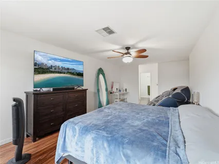 a bedroom with a bed and a flat screen tv