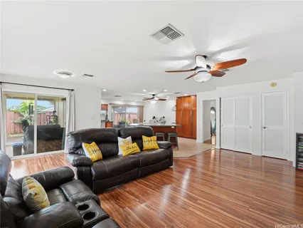 a living room with furniture and a ceiling fan