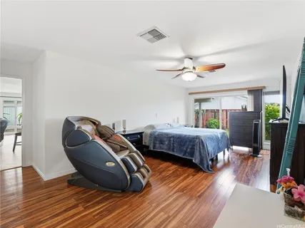 a bedroom with bed and a chandelier