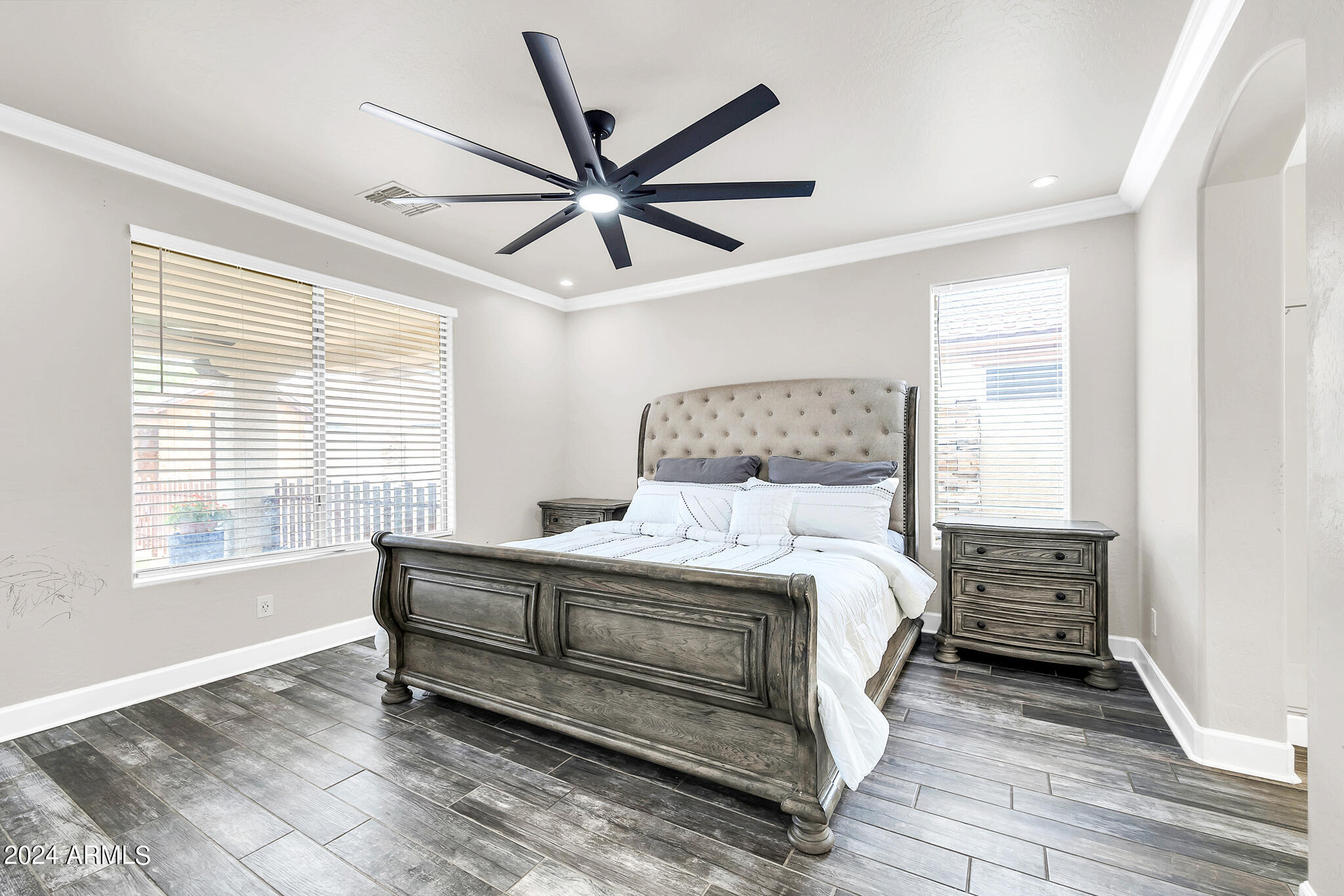 10125 West Payson Road Tolleson, AZ 85353 - Photo 11 of 35 a bedroom with a bed a dresser and a window