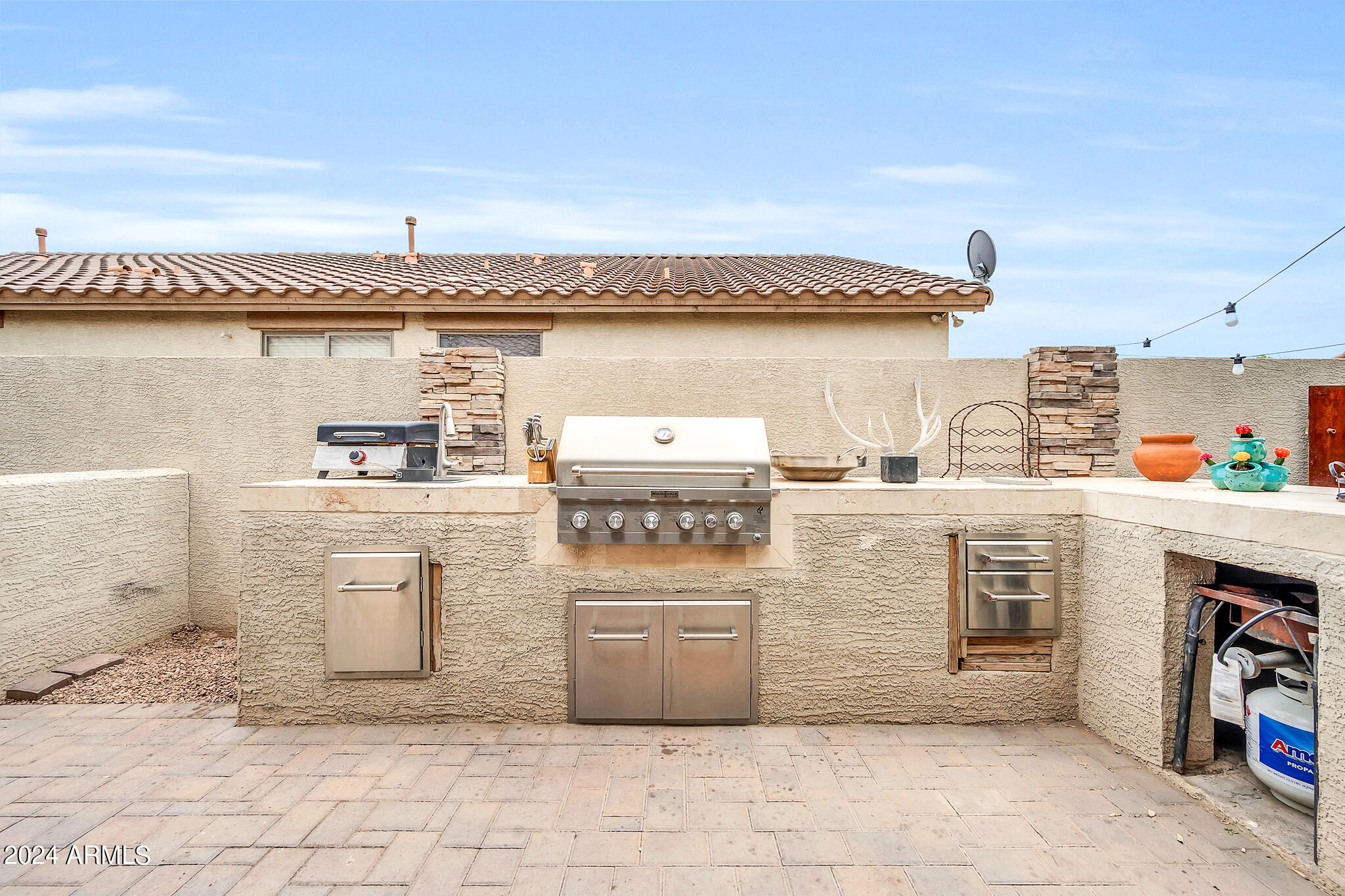 10125 West Payson Road Tolleson, AZ 85353 - Photo 21 of 35 a kitchen with stainless steel appliances granite countertop a stove a sink and a refrigerator