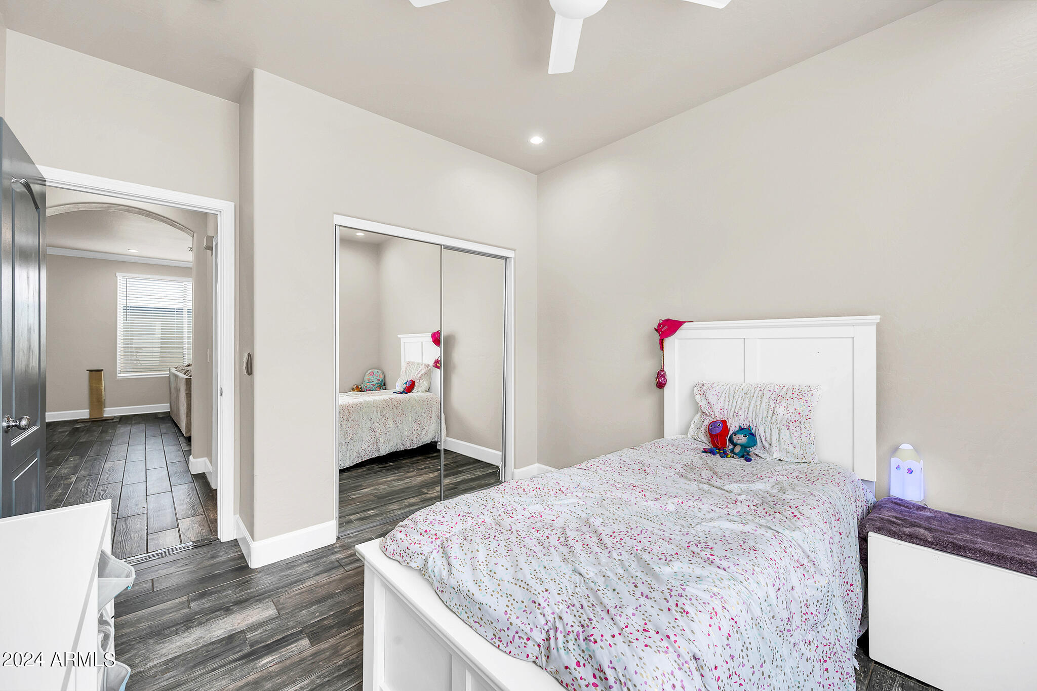 10125 West Payson Road Tolleson, AZ 85353 - Photo 26 of 35 a bedroom with a bed and wooden floor