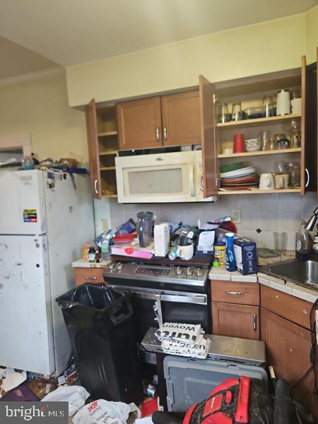 2305 Rhawn Street Philadelphia, PA 19152 - Photo 12 of 19 a kitchen with a stove and cabinets