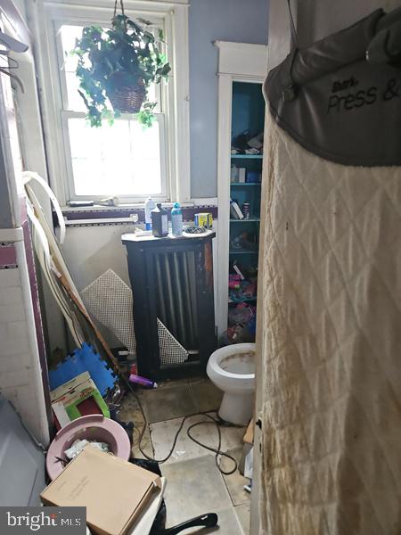 2305 Rhawn Street Philadelphia, PA 19152 - Photo 15 of 19 a bathroom with a toilet and a shower curtain
