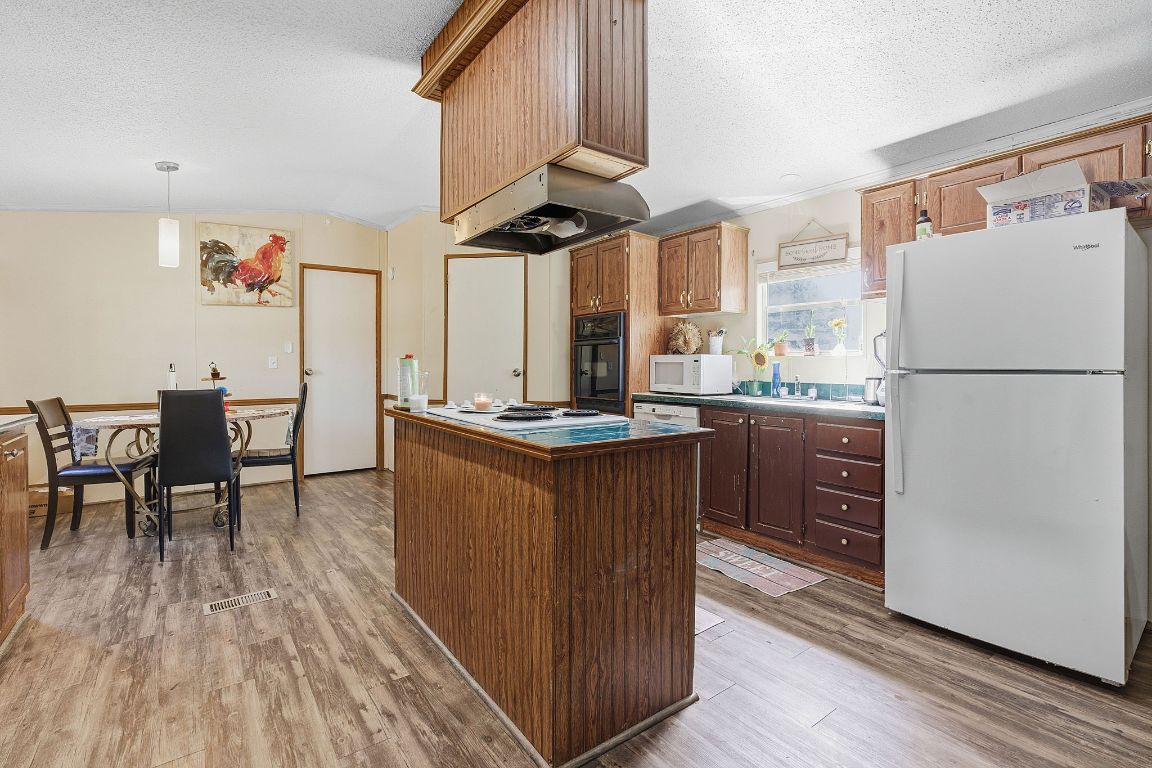 155 Forister Ranch Drive Dale, TX 78616 - Photo 11 of 30 a kitchen with stainless steel appliances granite countertop a refrigerator a sink a stove and a refrigerator